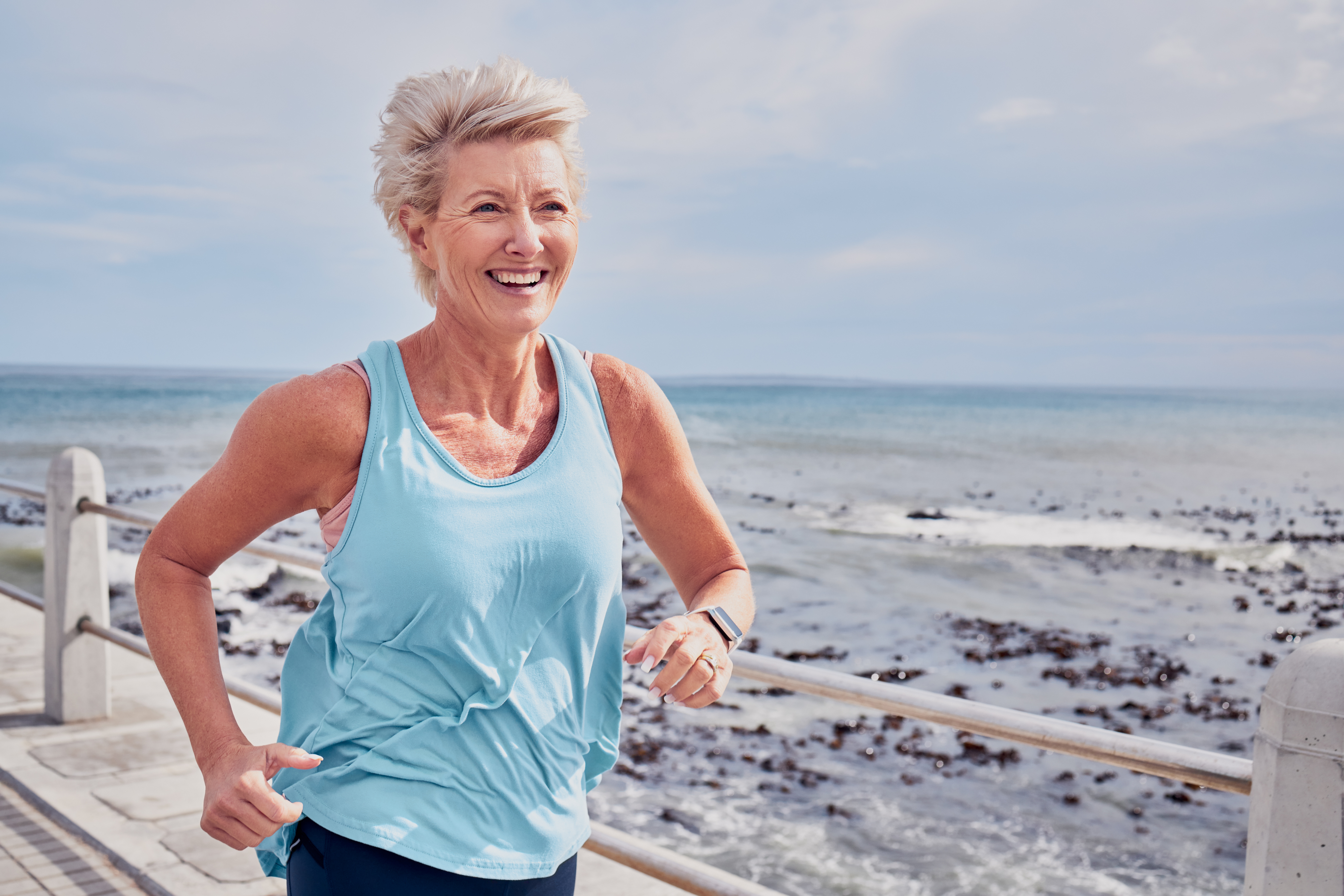 smiling-senior-woman-jogging-near-the-beach-2026-03-25-02-20-34-utc